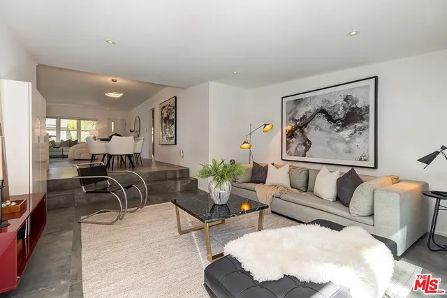 a living room with furniture and white walls