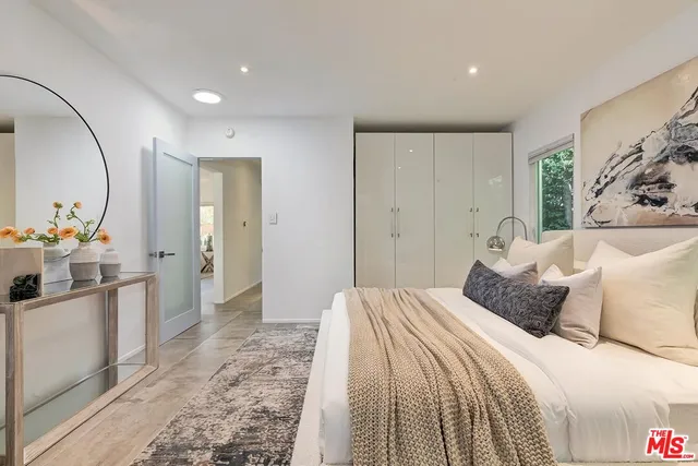 a bedroom with a bed and a mirror