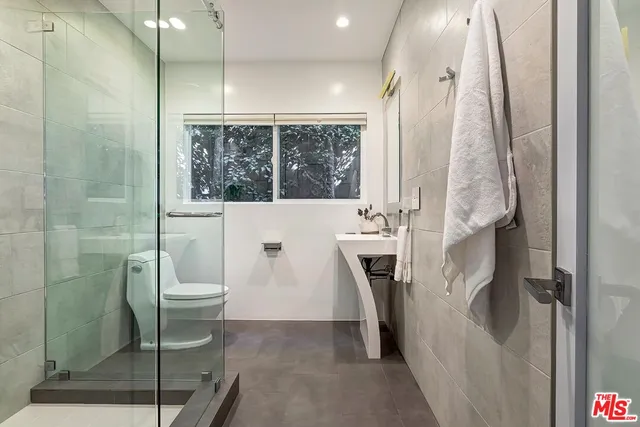 a bathroom with a toilet and a shower
