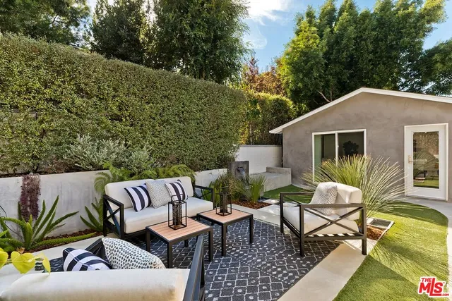 a view of a house with patio in the backyard