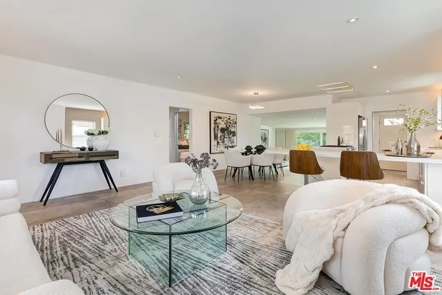 a living room with furniture and a mirror