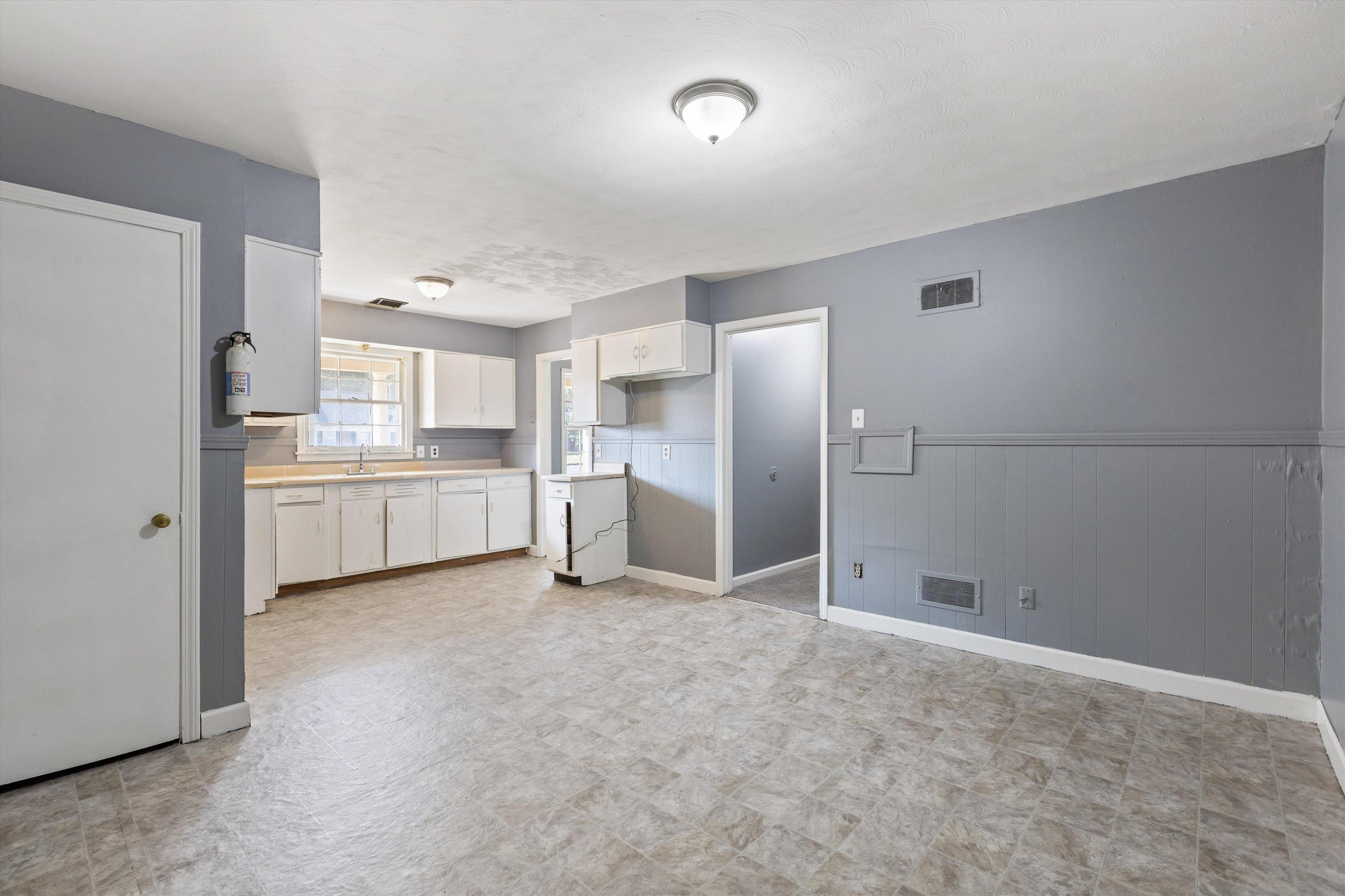 3580 Rhodes Avenue Memphis, TN 38111 - Photo 12 of 26 a view of a kitchen with white cabinets and stainless steel appliances