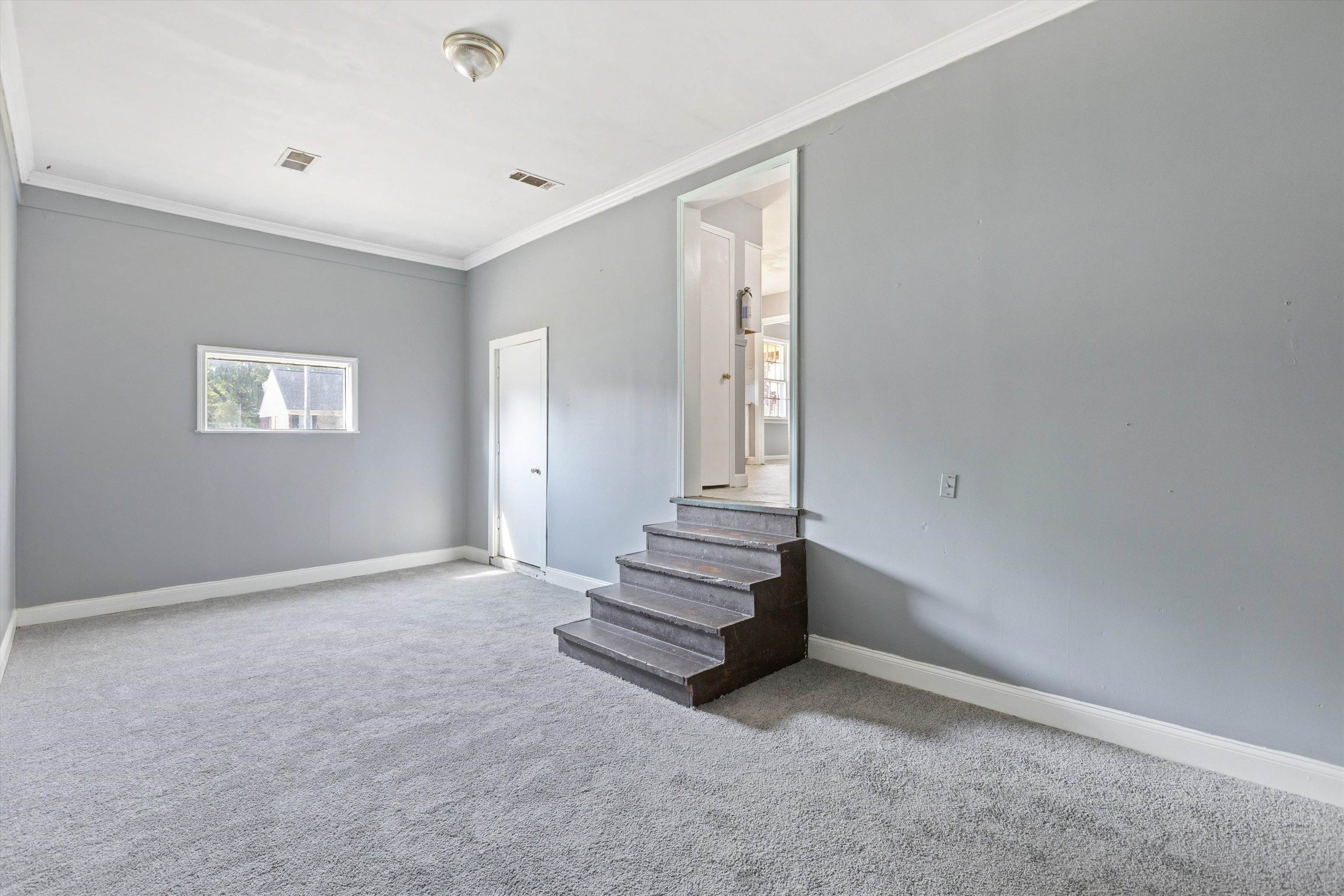 3580 Rhodes Avenue Memphis, TN 38111 - Photo 13 of 26 a view of an empty room with stairs and a window