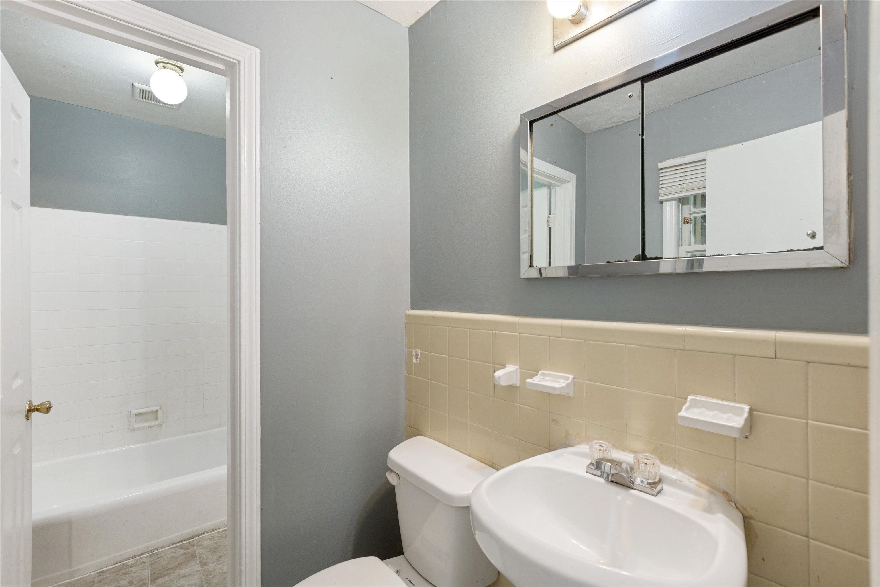 3580 Rhodes Avenue Memphis, TN 38111 - Photo 18 of 26 a bathroom with a toilet sink and mirror