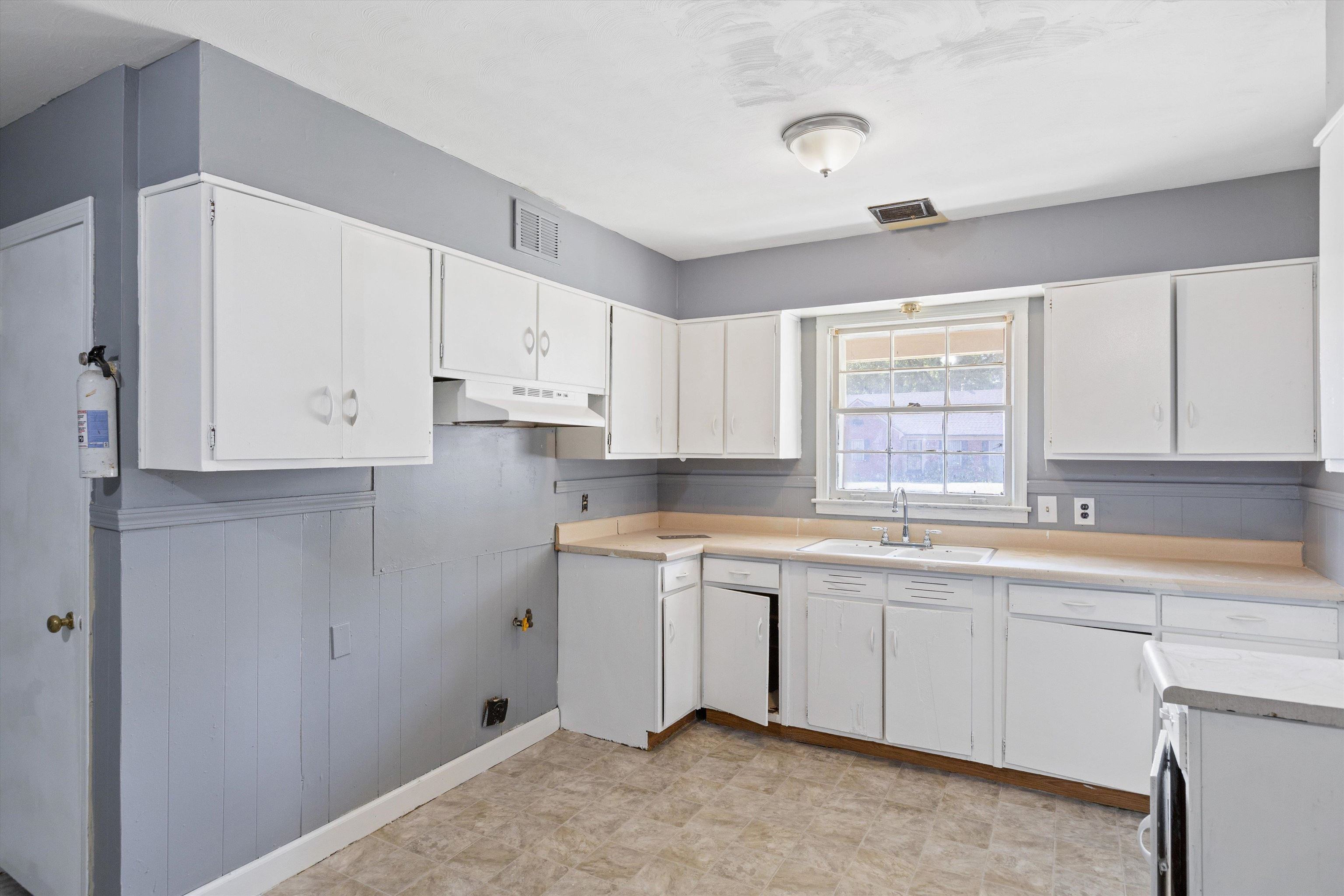 3580 Rhodes Avenue Memphis, TN 38111 - Photo 8 of 26 a kitchen with a sink window and cabinets