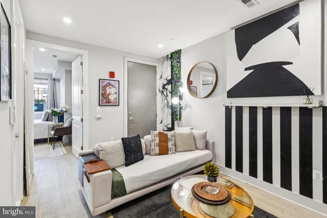 a living room with furniture and a white door