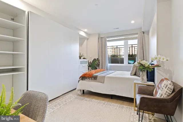 a bedroom with a bed and chair