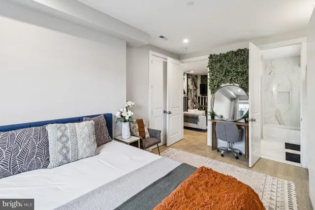 a bedroom with a bed and wooden floor