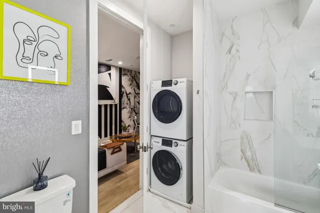 a view of a bedroom with washer and dryer