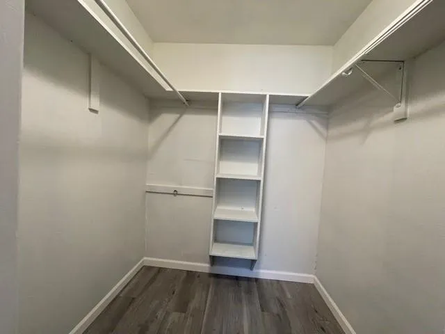a view of walk in closet with empty racks
