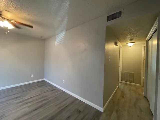 a view of hallway with wooden floor