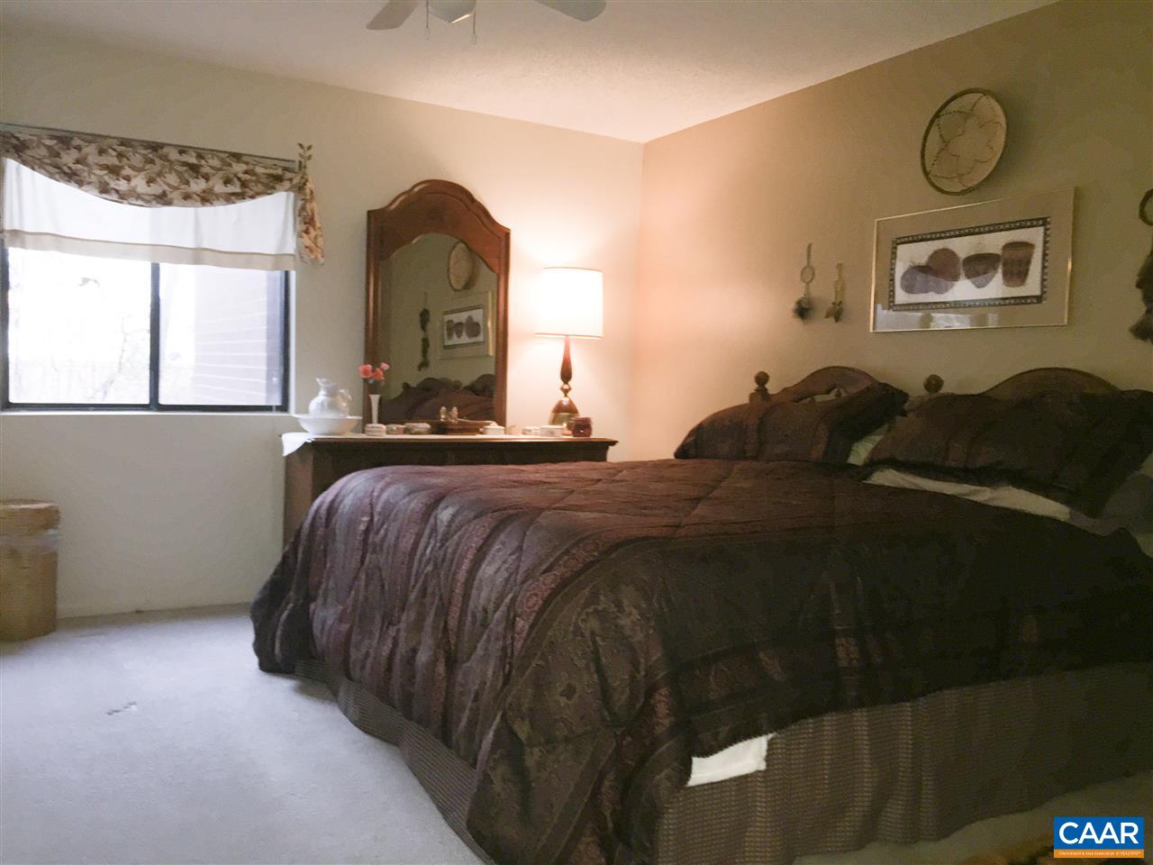 125 Turtle Creek Road, Unit 3 Charlottesville, VA 22901 - Photo 3 of 14 a bedroom with a bed and a painting on the wall