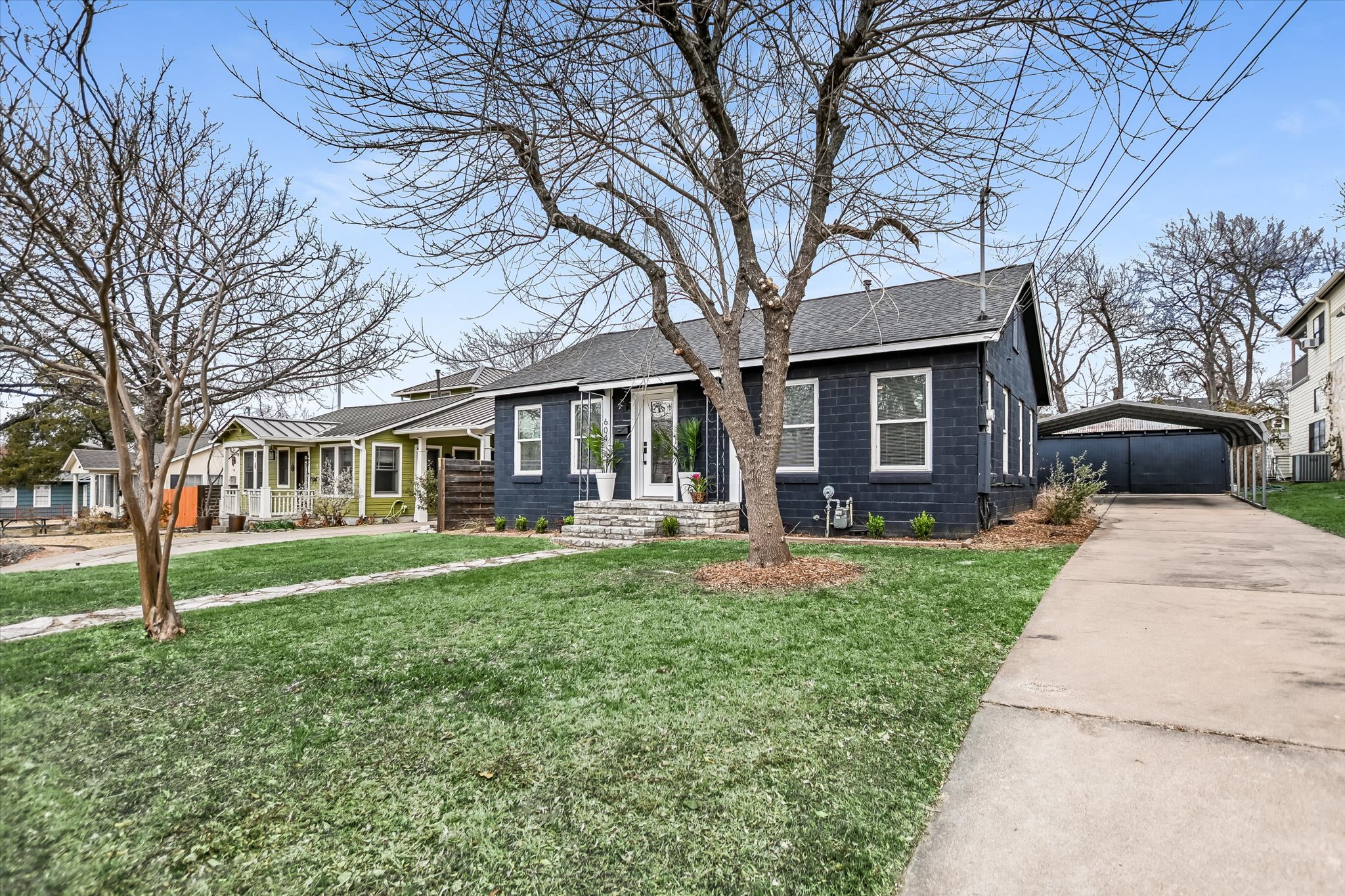 a front view of a house with a yard and tree s
