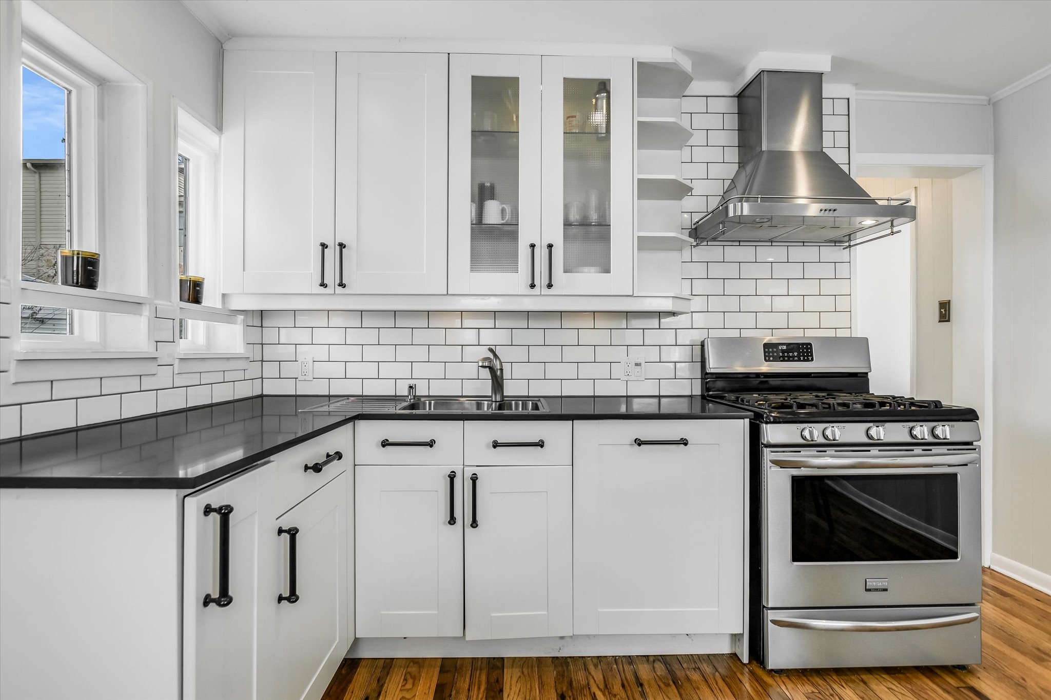 604 East 46th Street Austin, TX 78751 - Photo 8 of 16 a kitchen with granite countertop a stove sink and cabinets