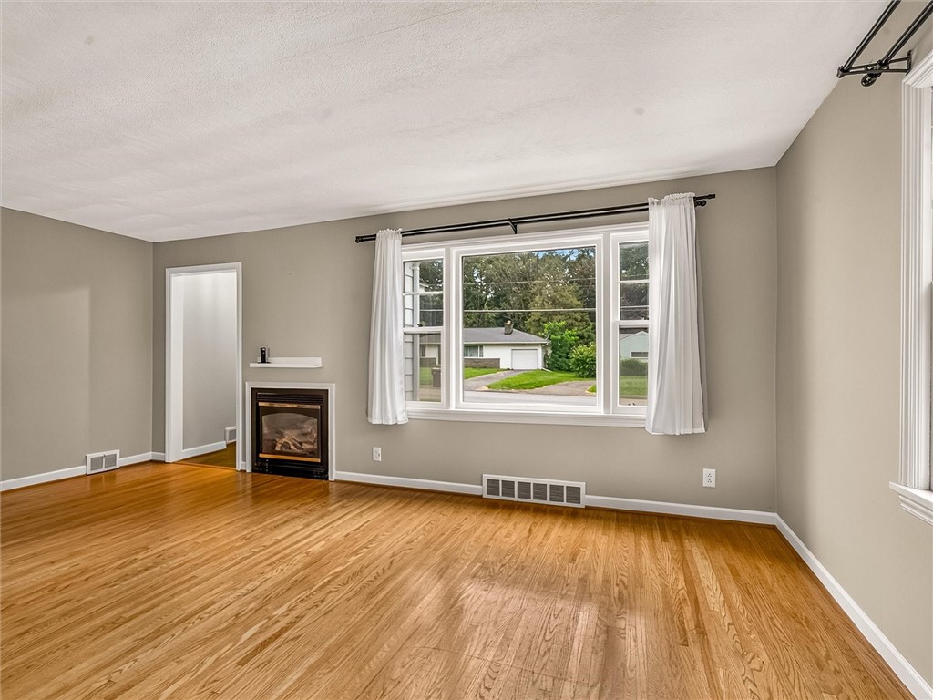 508 Roosevelt Road East Rochester, NY 14445 - Photo 4 of 30 Living room with well maintained oak hardwood floo