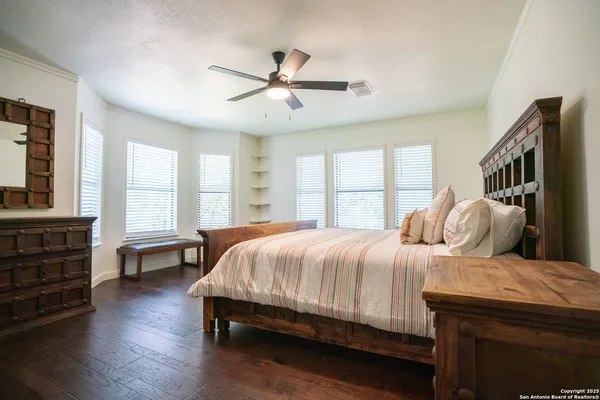 a bed sitting in a bedroom next to a window