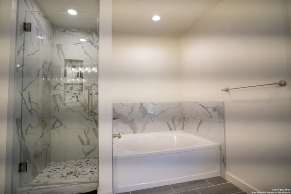 a kitchen with granite countertop white cabinets white stainless steel appliances a sink and a window
