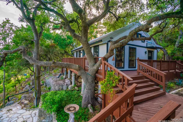 a backyard of a house with lots of trees