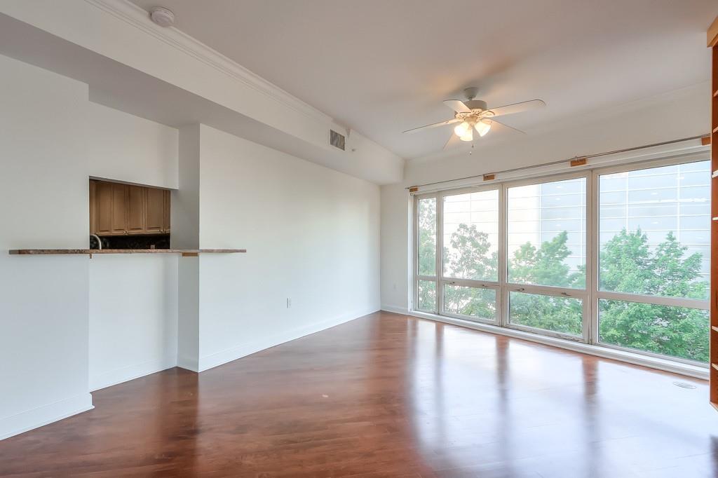 3475 Oak Valley Road Northeast, Unit 530 Atlanta, GA 30326 - Photo 12 of 37 wooden floor in an empty room with a window