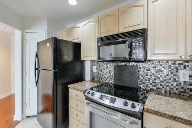 a stove top oven sitting inside of a kitchen