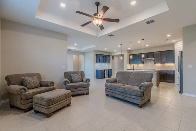 a kitchen with stainless steel appliances kitchen island granite countertop a refrigerator and cabinets