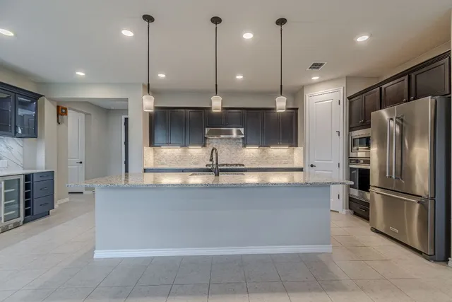 a living room with furniture and kitchen view