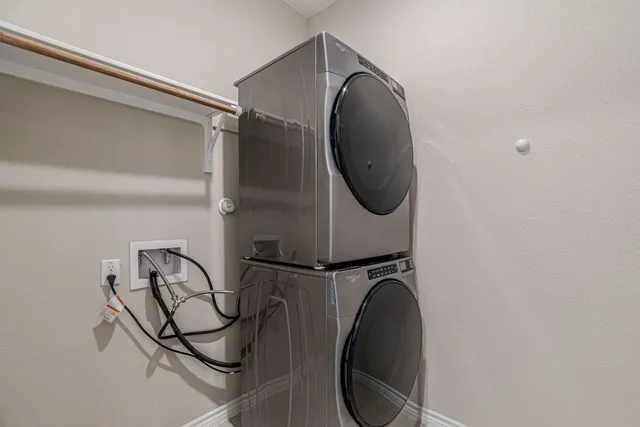 a large kitchen with granite countertop a large counter top stainless steel appliances and cabinets