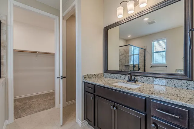 an empty room with window and ceiling fan
