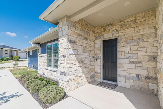 a view of a porch with a table and chairs