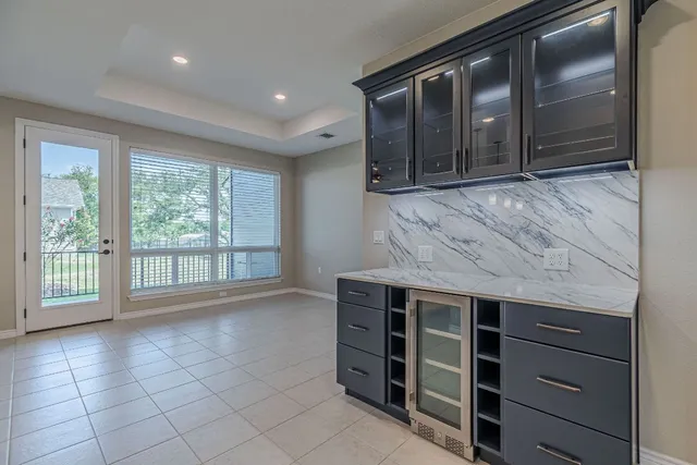 a kitchen with kitchen island a counter space appliances and cabinets