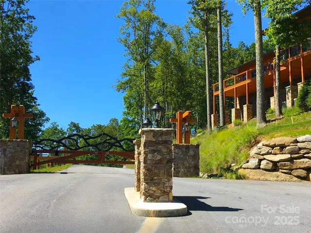 a view of a street with potted plants and large trees
