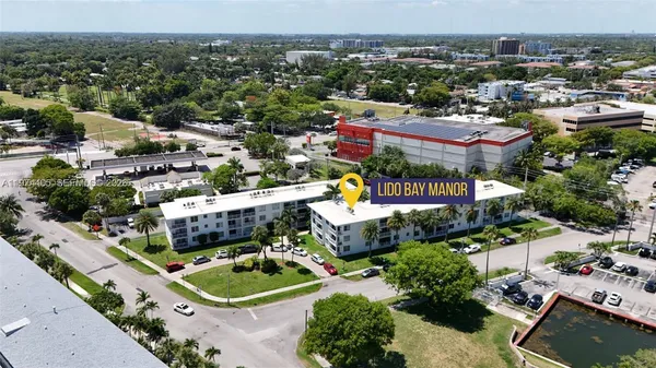 an aerial view of a house with a garden and lake view