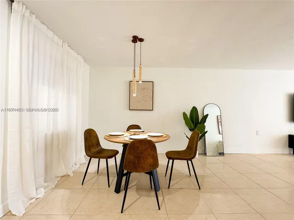 a view of a room with furniture and a window