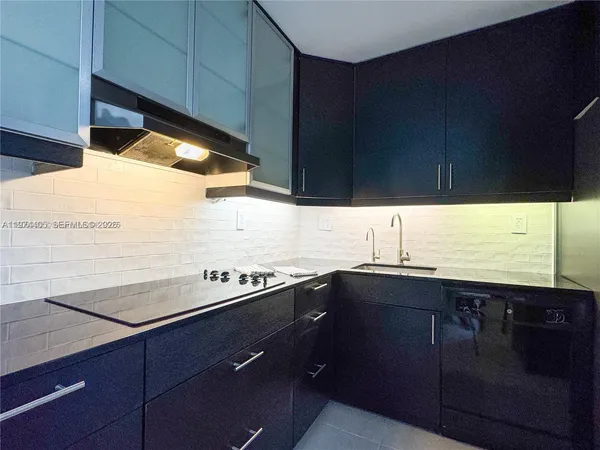 a kitchen with a sink and cabinets