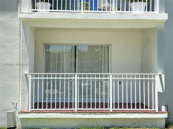 a view of a balcony with a white door
