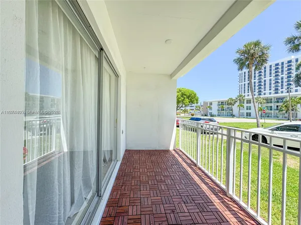 a view of a balcony with wooden floor