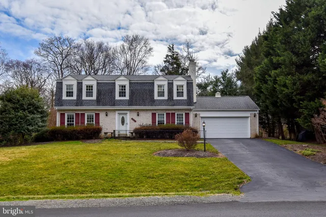 a front view of house with yard and trees