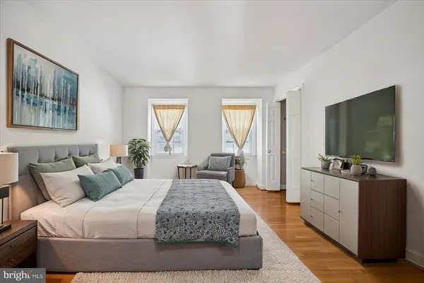 a bedroom with a large bed and a flat screen television