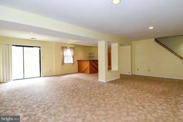 an empty room with a window and fireplace