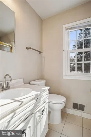 a bathroom with a sink toilet and a mirror