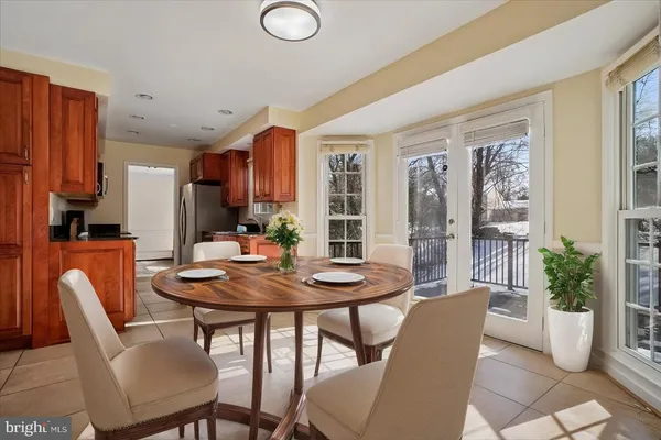 a view of a dining room with furniture and a potted plant