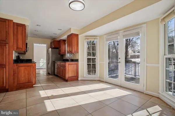 a kitchen with stainless steel appliances granite countertop a refrigerator and a stove