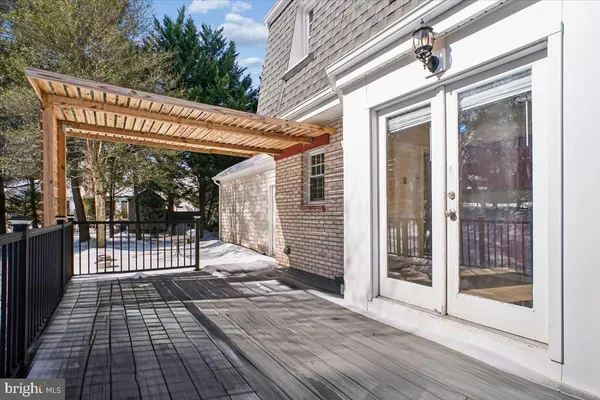 a view of a porch with wooden floor and iron stairs
