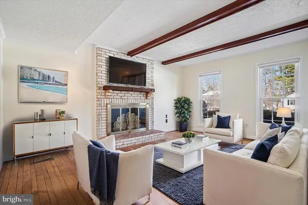 a living room with furniture fireplace and flat screen tv