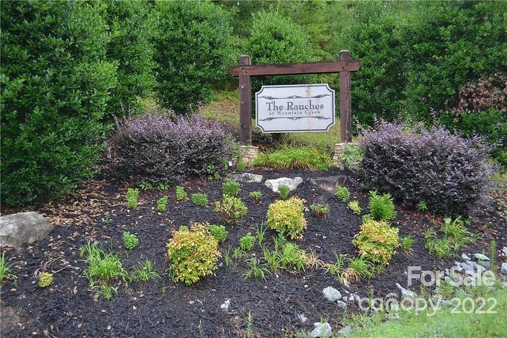 a sign that is sitting in the middle of garden