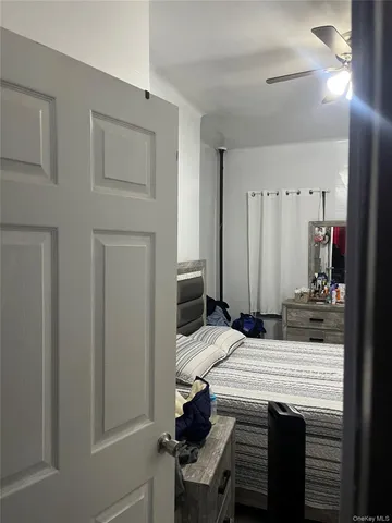 a bedroom with a bed and a mirror