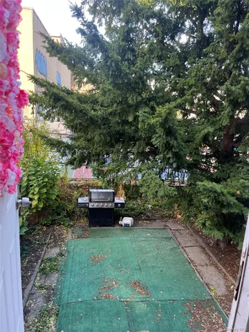a backyard of a house with a table and chairs