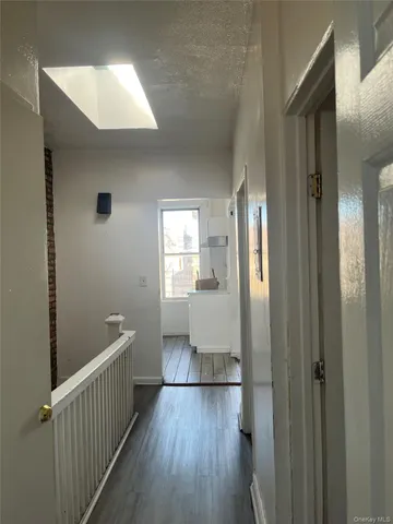 a view of hallway with wooden floor