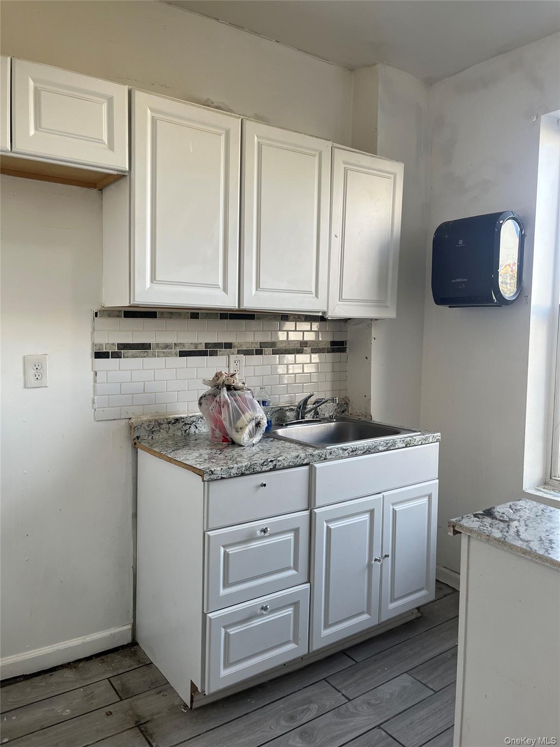 2393 Walton Avenue Bronx, NY 10468 - Photo 9 of 13 a kitchen with stainless steel appliances granite countertop a sink stove and cabinets