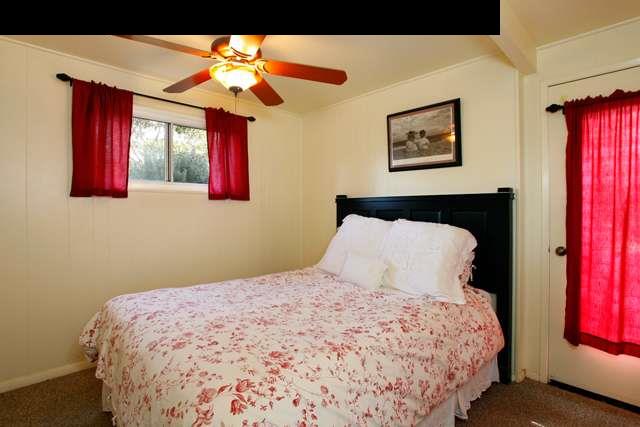 223 Ainakula Road Kula, HI 96790 - Photo 15 of 30 a bedroom with a large bed and a chandelier